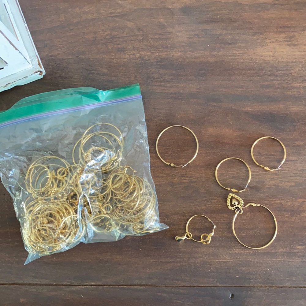 three different sizes of gold hoops and charms